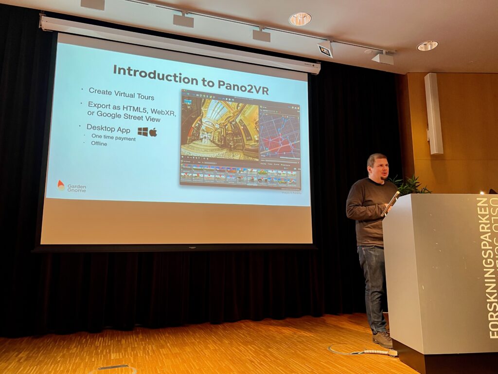 Thomas speaking at VR Oslo. Podium and projector screen showing Pano2VR.