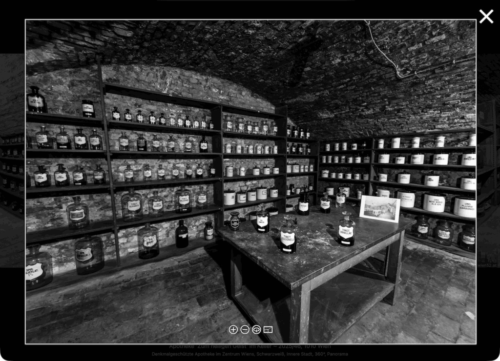 Screenshot of black-and-white 360° panorama of the apothecary basement with shelves of historic medicine bottles, displayed in a minimal viewer.